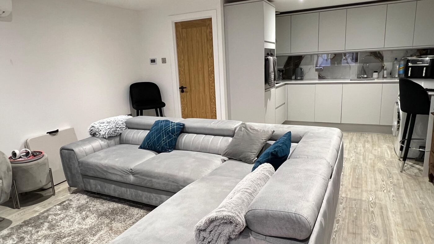 Open-plan living room and kitchen inside a finished garden annexe